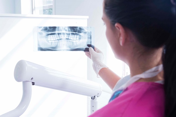 dentist examining x-ray