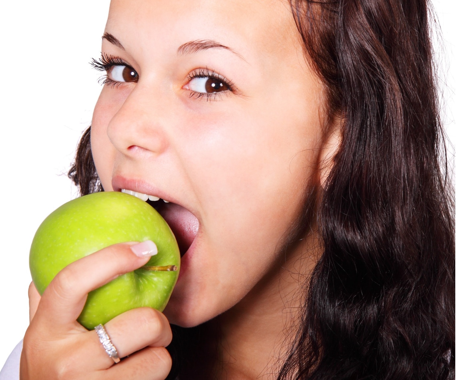 young girl eating a green apple