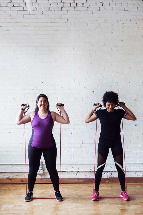 two woman-strong-band-exercise